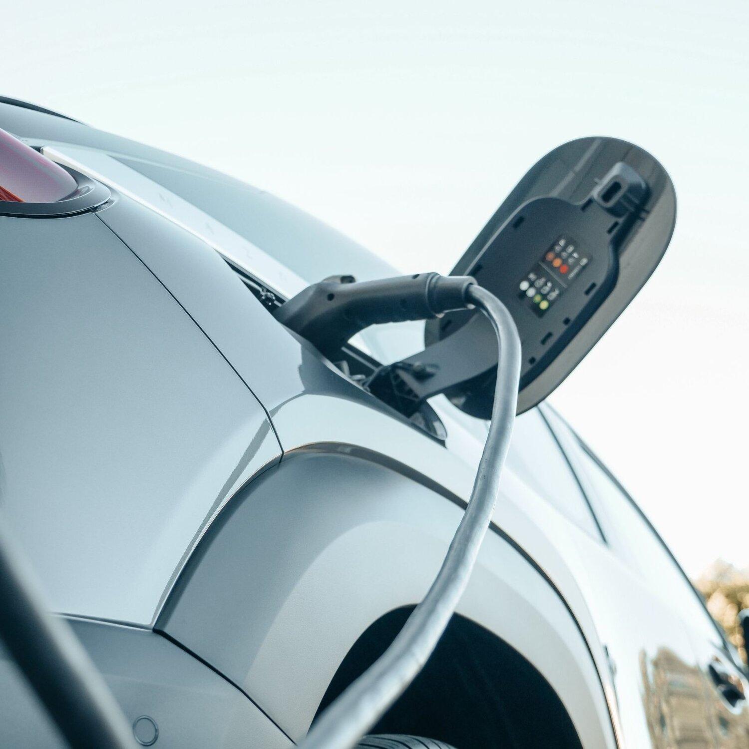 Electric car plugged in at a charging station